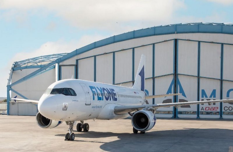 Uzbekistan's FlyOne Asia aircraft in front of Joramco MRO facility